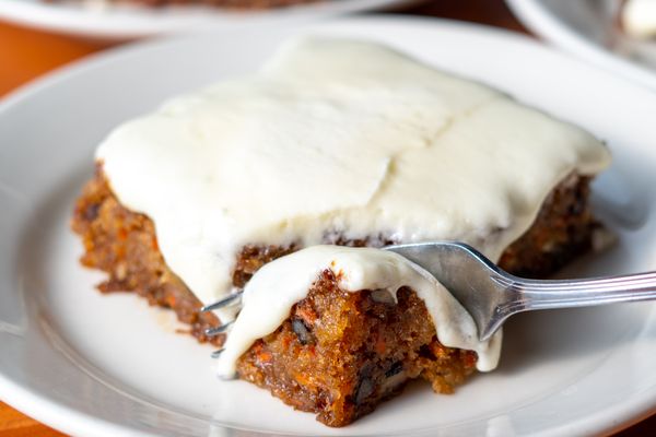 Photo of J. Alexander's - Nashville, TN, US. a slice of carrot cake on a plate with a fork