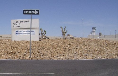 Photo of High Desert State Prison - Indian Springs, NV, US. Sign out front of the prison and round about leading to prison