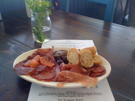 Photo of The Fremont Diner - Sonoma, CA, US. Country Meat Platter, Dry Aged Berkshire Pork, Chorizo, Prosciutto, Salami, Griddled Bread, Pickled Chelan Cherries  $7.50