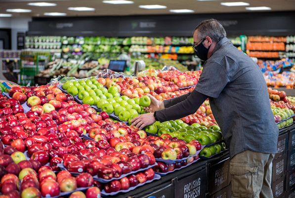 Photo of Stop & Shop - Cranston, RI, US. Wide shot of associate stocking fresh produce.