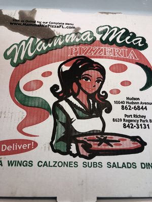 Photo of Mamma Mia Pizzeria - Port Richey, FL, US. a woman holding a pizza