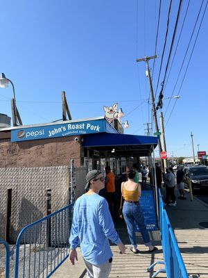 Photo of John's Roast Pork - Philadelphia, PA, US. people walking down the sidewalk