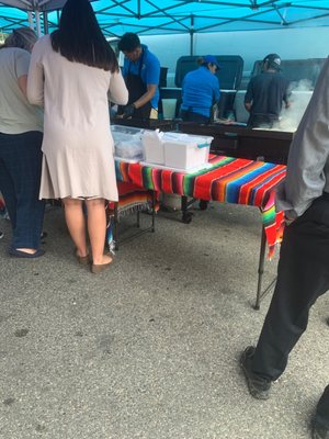 Photo of Taco Loco - Washington, DC, DC, US. a group of people standing around a table