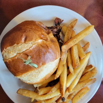 Pulled pork sandwich with apple slices.