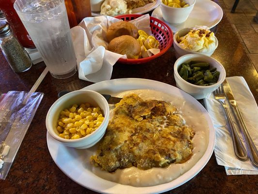 Photo of Pioneer of Texas - Wichita Falls, TX, US. Chicken Fried Steak lunch special with green beans, loaded mashed potatoes & corn