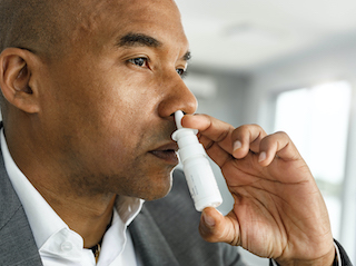 A man using nasal spray