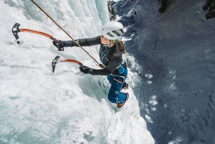 woman ice climbing while wearing fleece