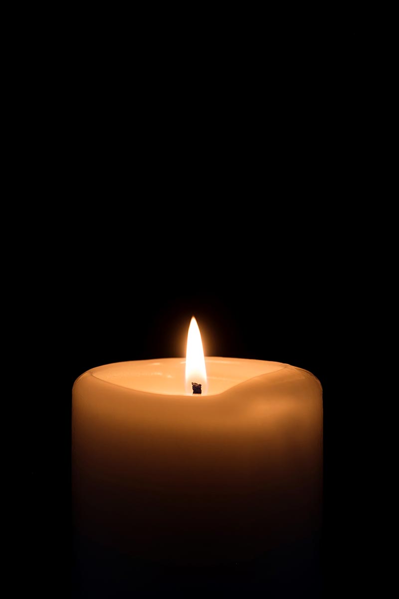 Vertical view of a candle against a black background - StockFreedom -  Premium Stock Photography