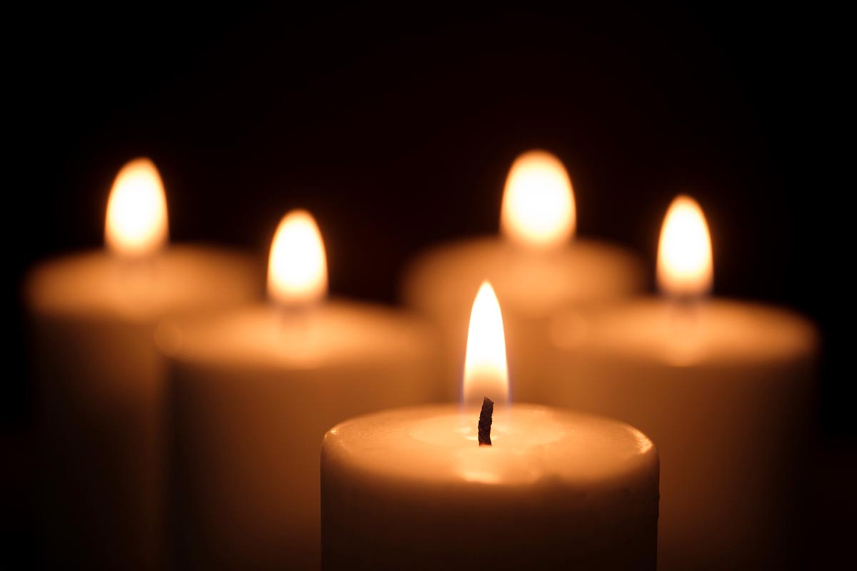 Group of lit candles agains a black background - StockFreedom - Premium  Stock Photography