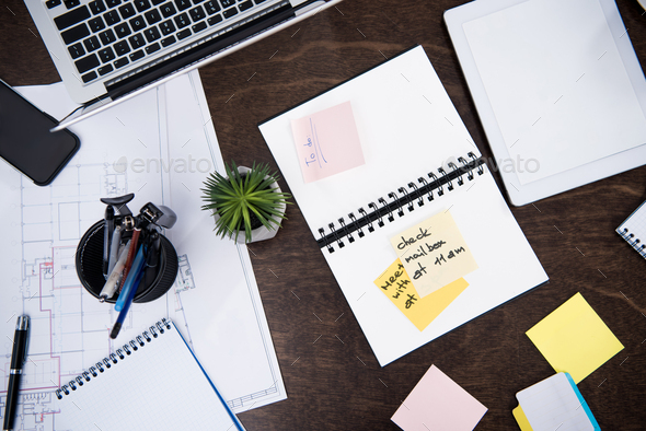 flat lay with laptop, notepads, sticky notes and office supplies on ...