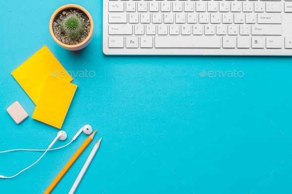 Office table desk with supplies on blue background, Top view and copy space  for text Stock Photo by FabrikaPhoto