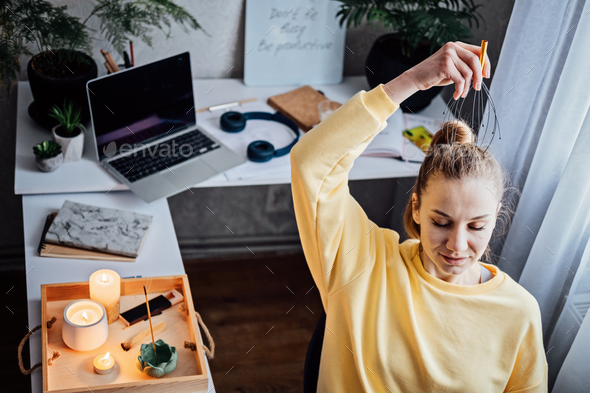 Woman on workplace with Head Massager Scalp Scratcher with Fingers. Self-massage with Head