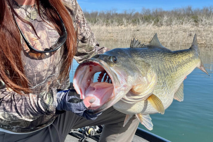 a woman poses with a fish