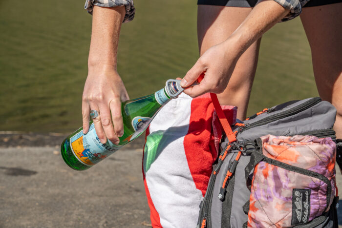 opening bottle of water with bottle opener 