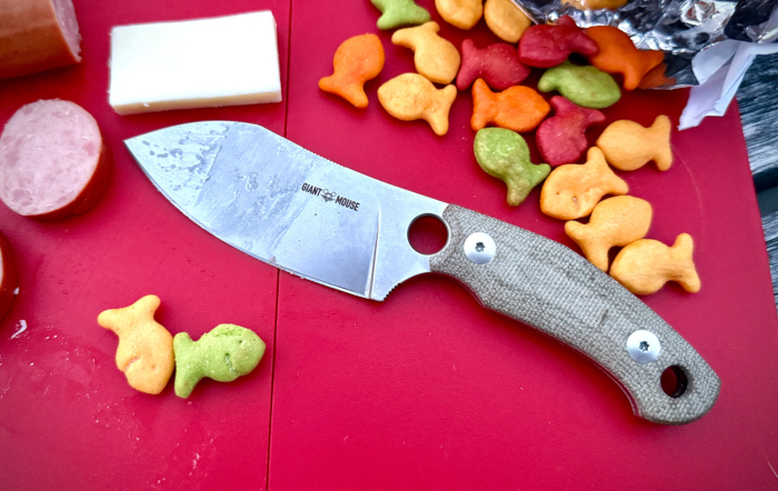 giantmouse gmf1 xl pocket fixed blade knife on cutting board with cheese, meat, and goldfish snacks