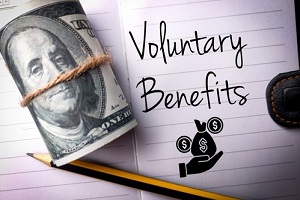 banknotes and icon with text voluntary benefits on a notebook background