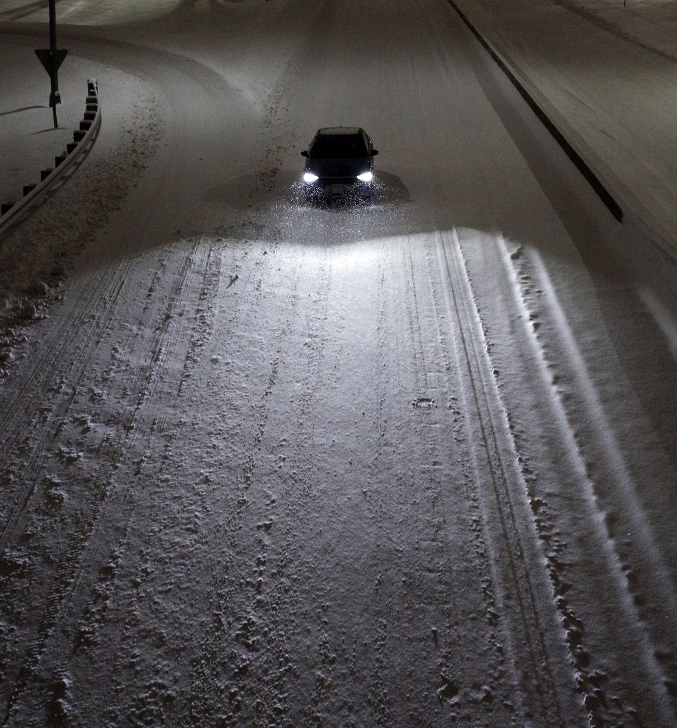 Car driving on unplowed highway