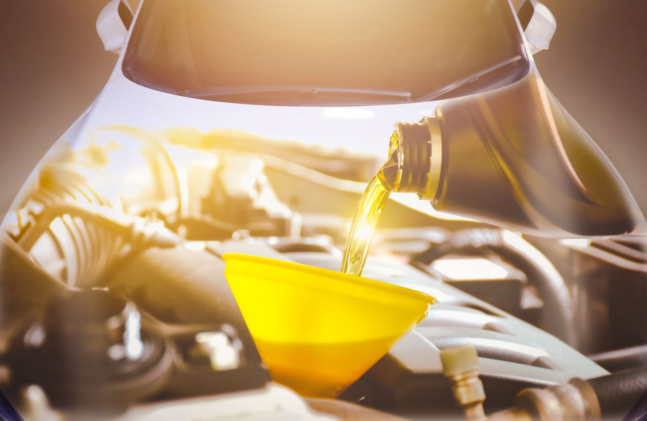 engine oil pouring into car engine