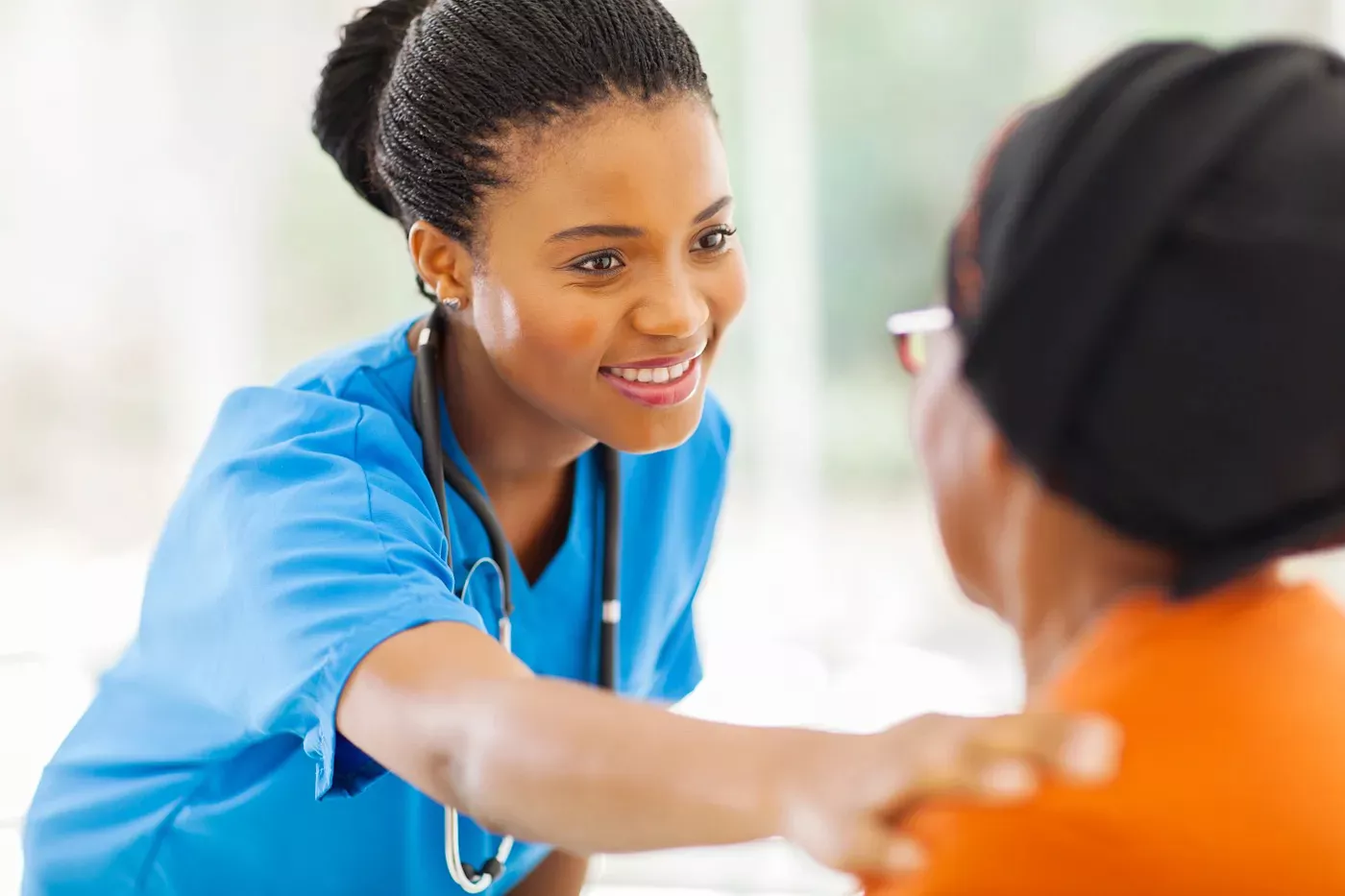 Nurse helping patient with hand on shoulder