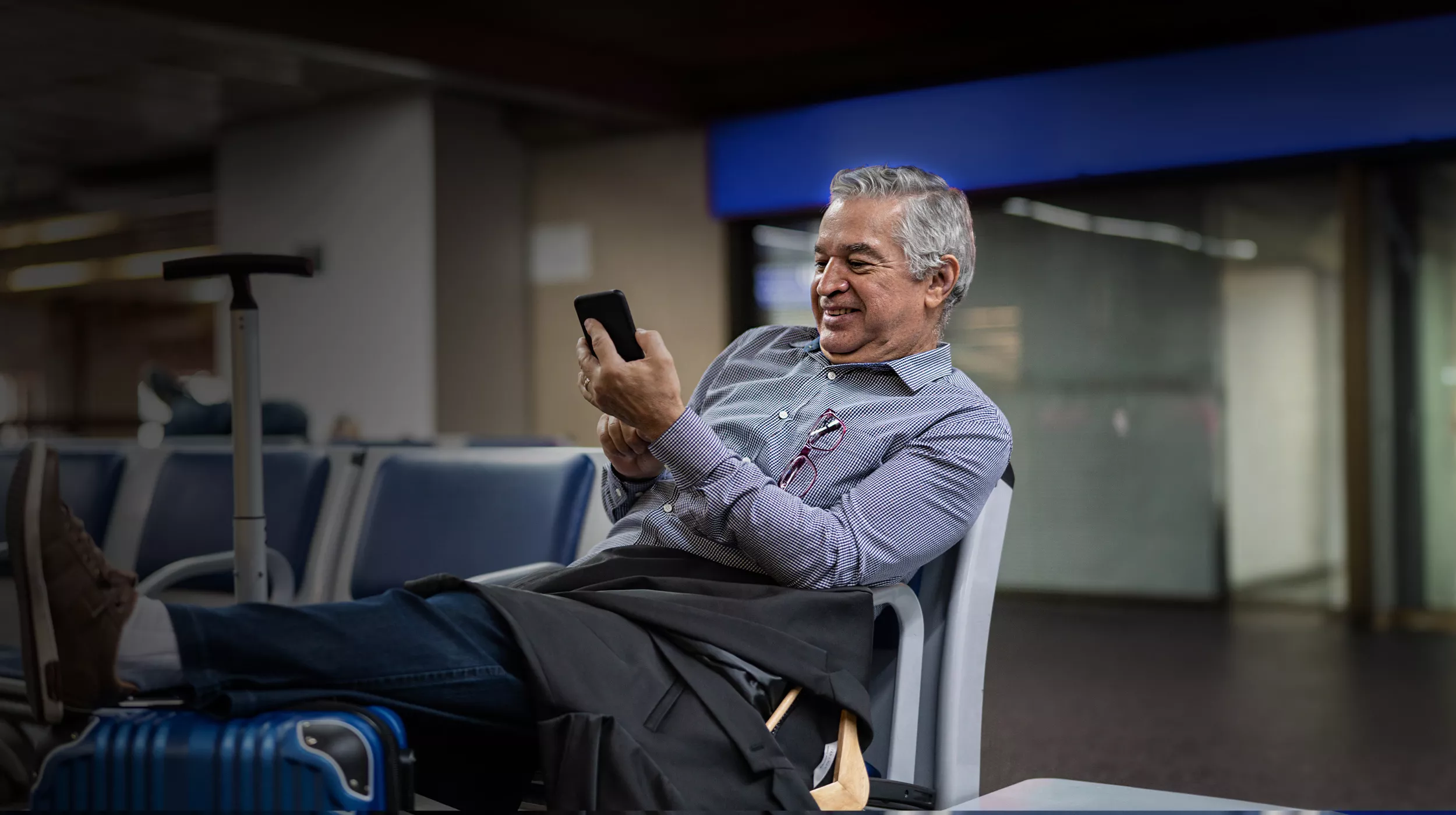 man looking at phone in terminal