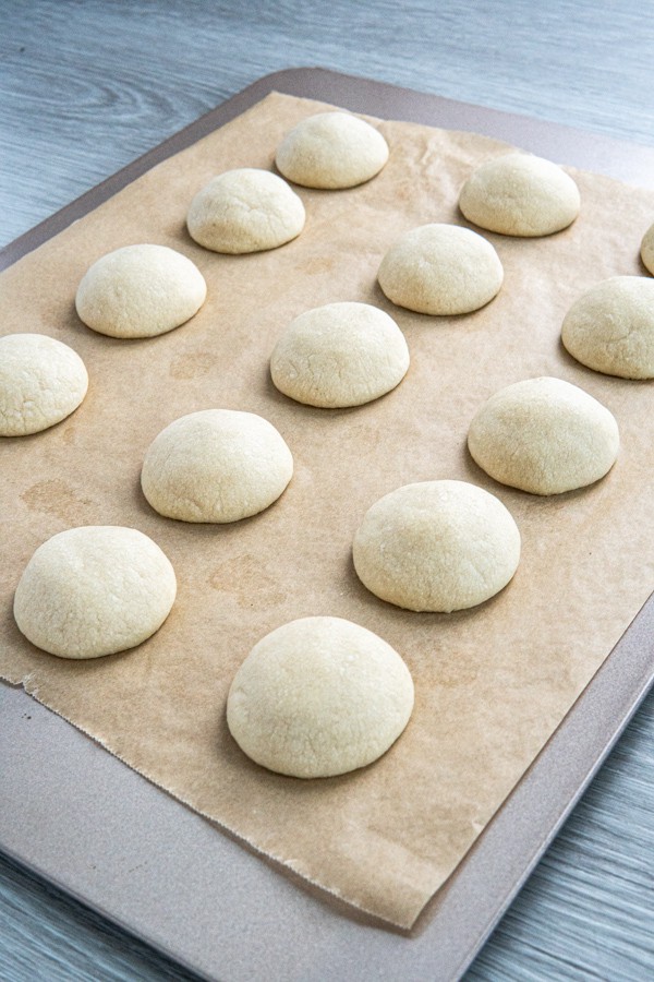 Snowball cookies with no nuts fresh out of the oven on a baking sheet.