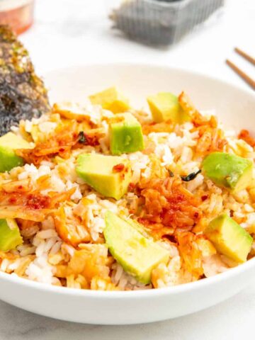 TikTok salmon and rice bowl served with sheets of nori, avocado, and kimchi.