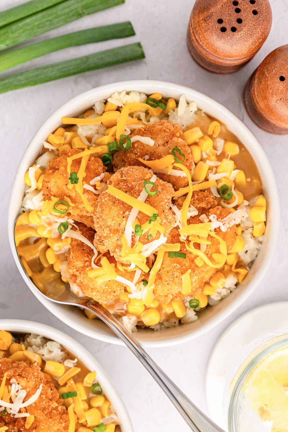 An overhead shot of a copycat KFC famous bowl with gravy, corn, and mashed potatoes.