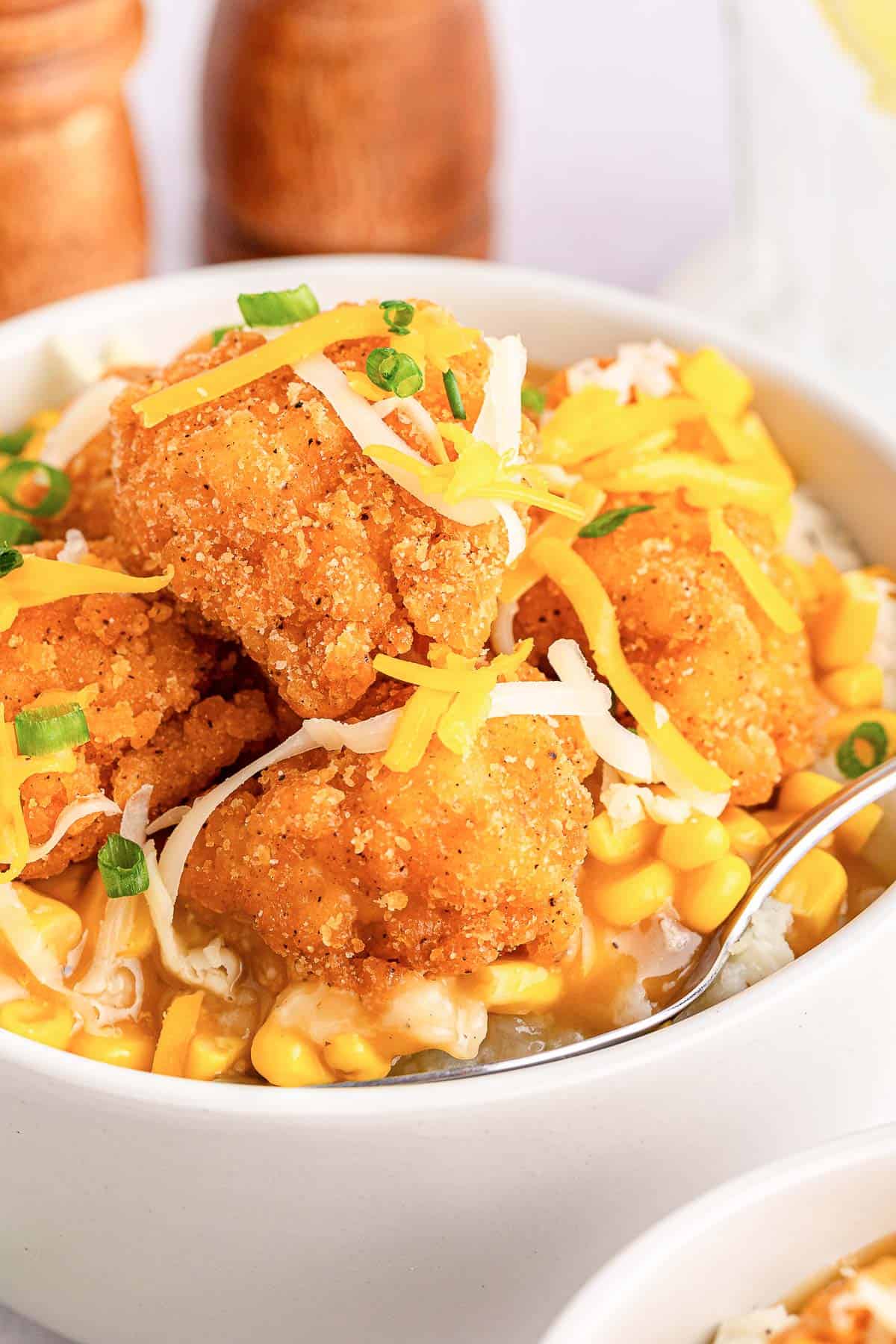 Copycat KFC famous bowl with popcorn chicken and corn kernels.