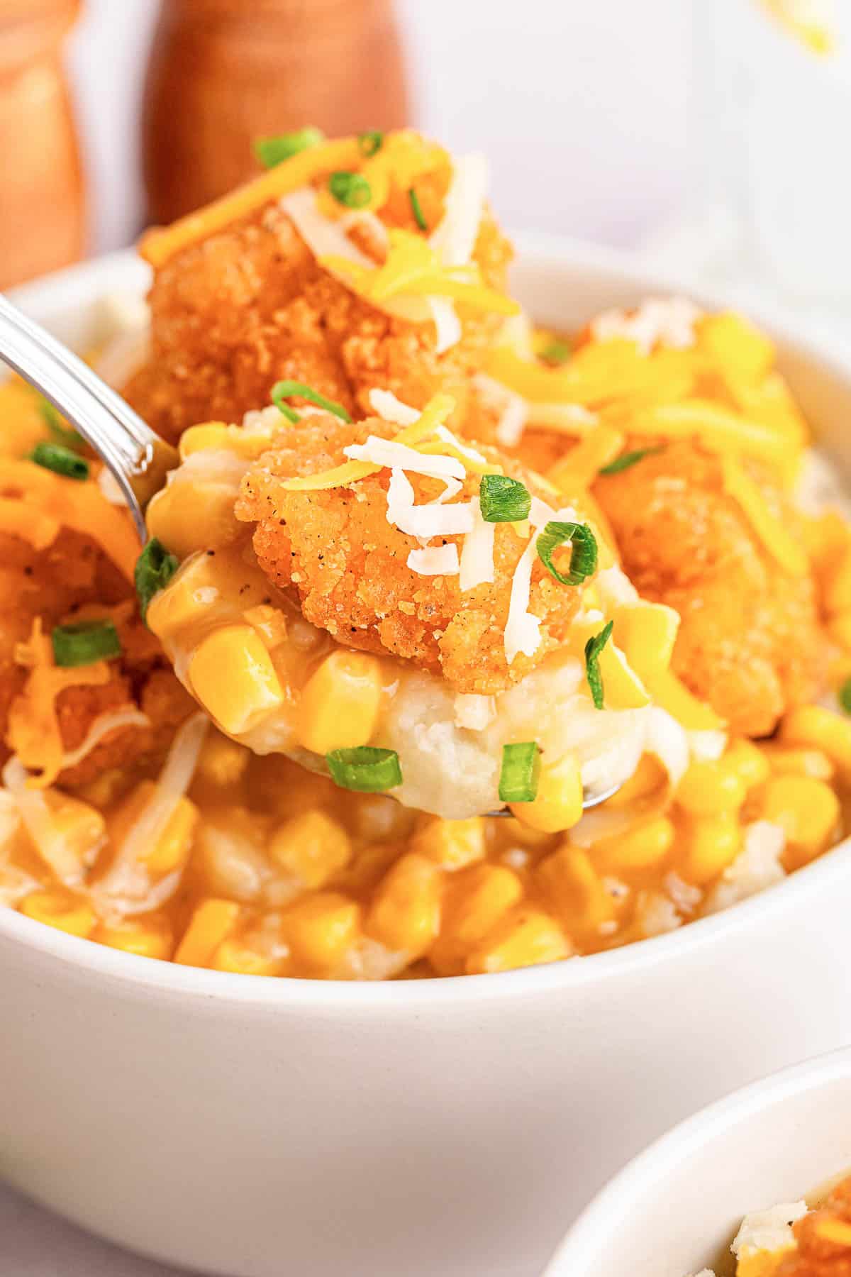 Homemade KFC famous bowl garnished with green onions.