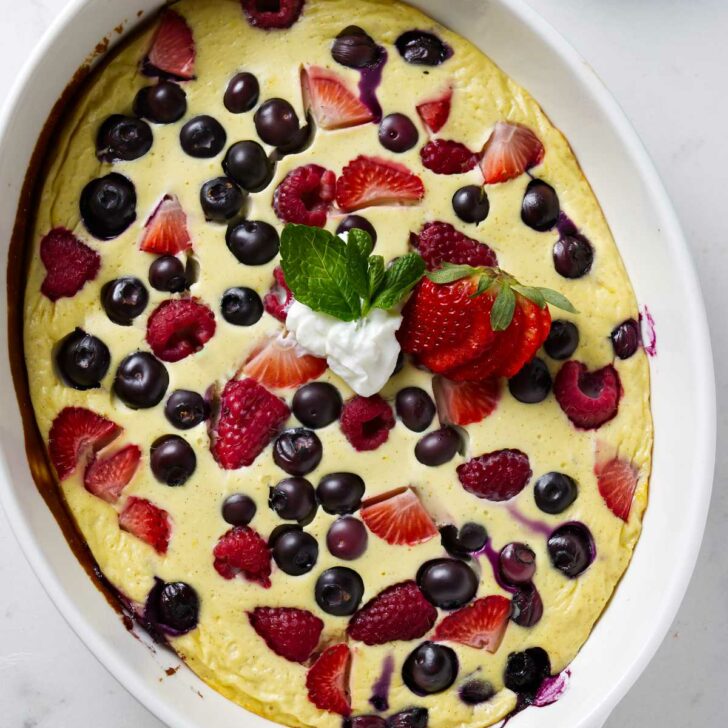 A baking dish with baked yogurt and eggs with berries.