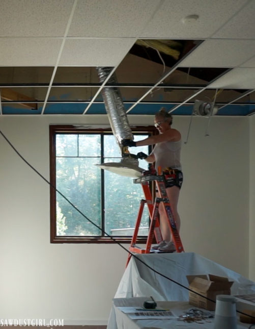 Removing drop ceiling air vents.