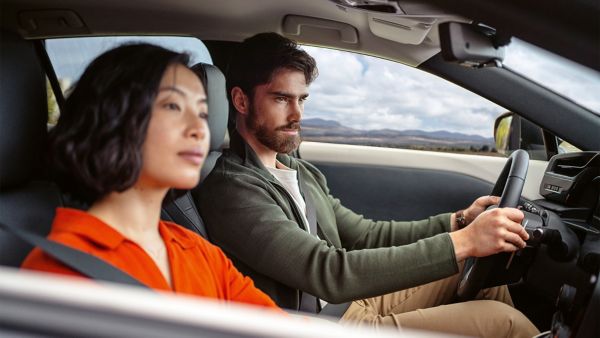 A woman and man sat in a Lexus RZ 450e