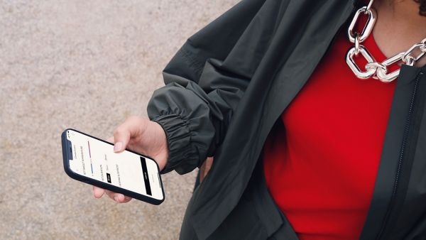 A woman using a mobile phone to access the Lexus Link app