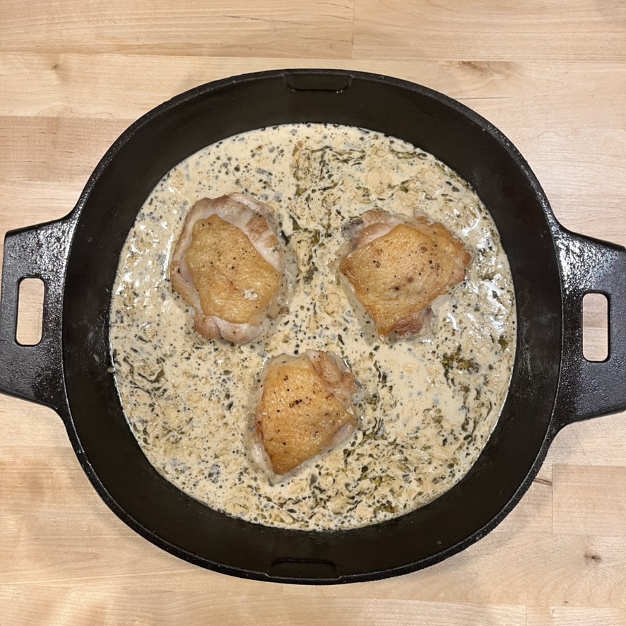 Creamy chicken thighs in cast iron skillet