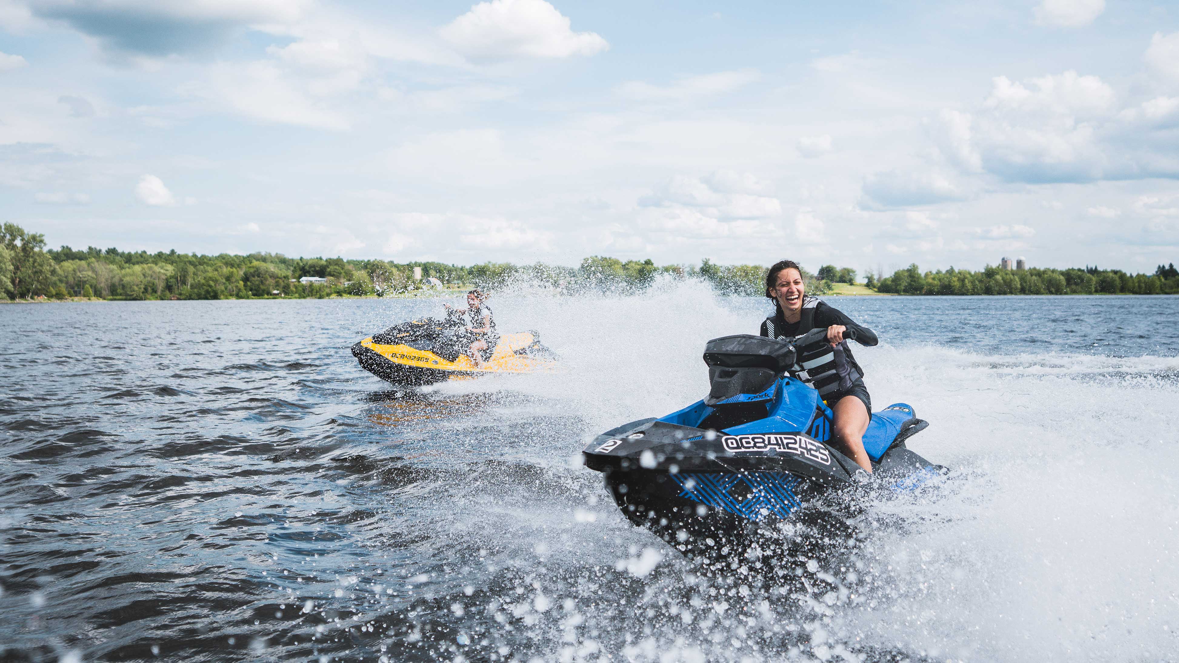 Two women having fun riding their own Sea-Doo personal watercraft