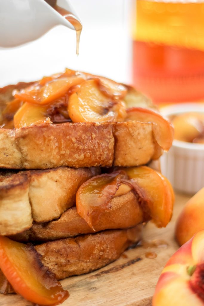 4 thick brioche slices with bourbon syrup and peach slices