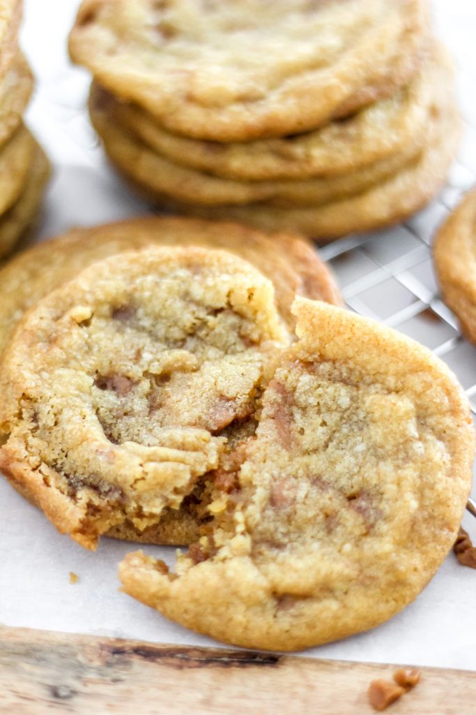 Browned Butter Skor Toffee Cookie in half on wooden board