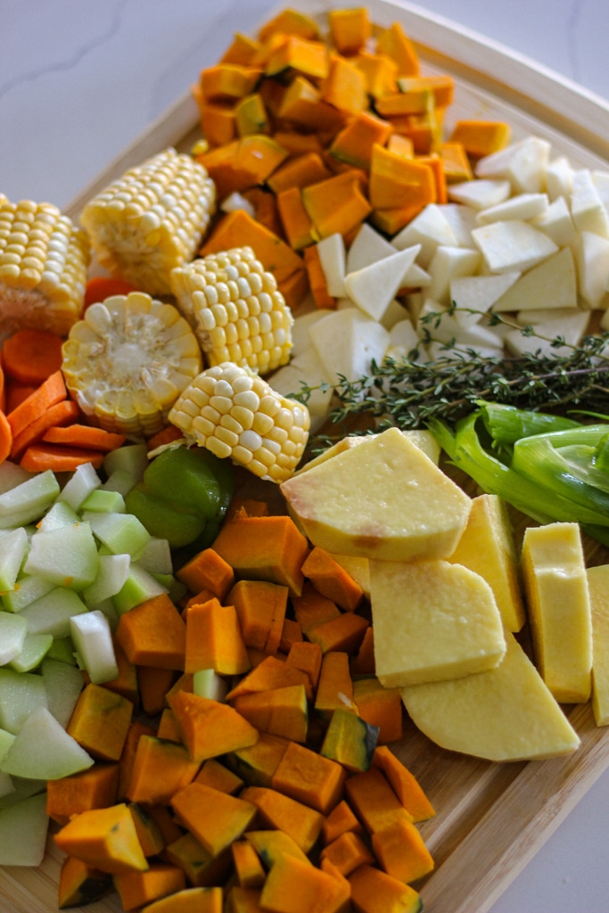 jamaican chicken soup fresh ingredients on a cutting board.