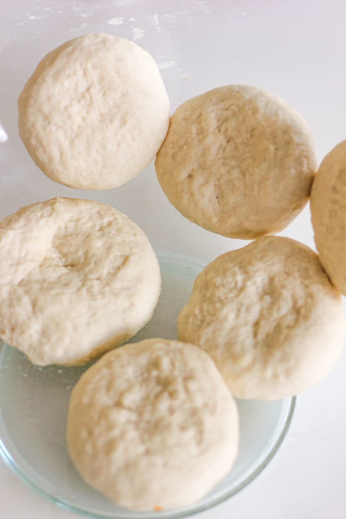 6 flour dumplings in glass bowl.