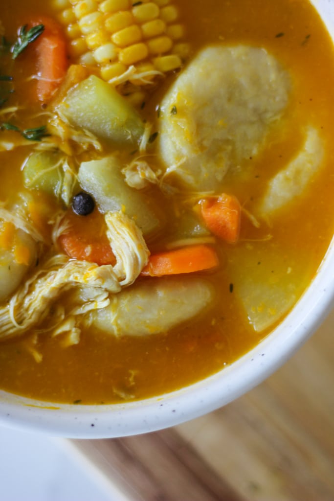 jamaican chicken soup with corn, dumpling, carrots and chicken.