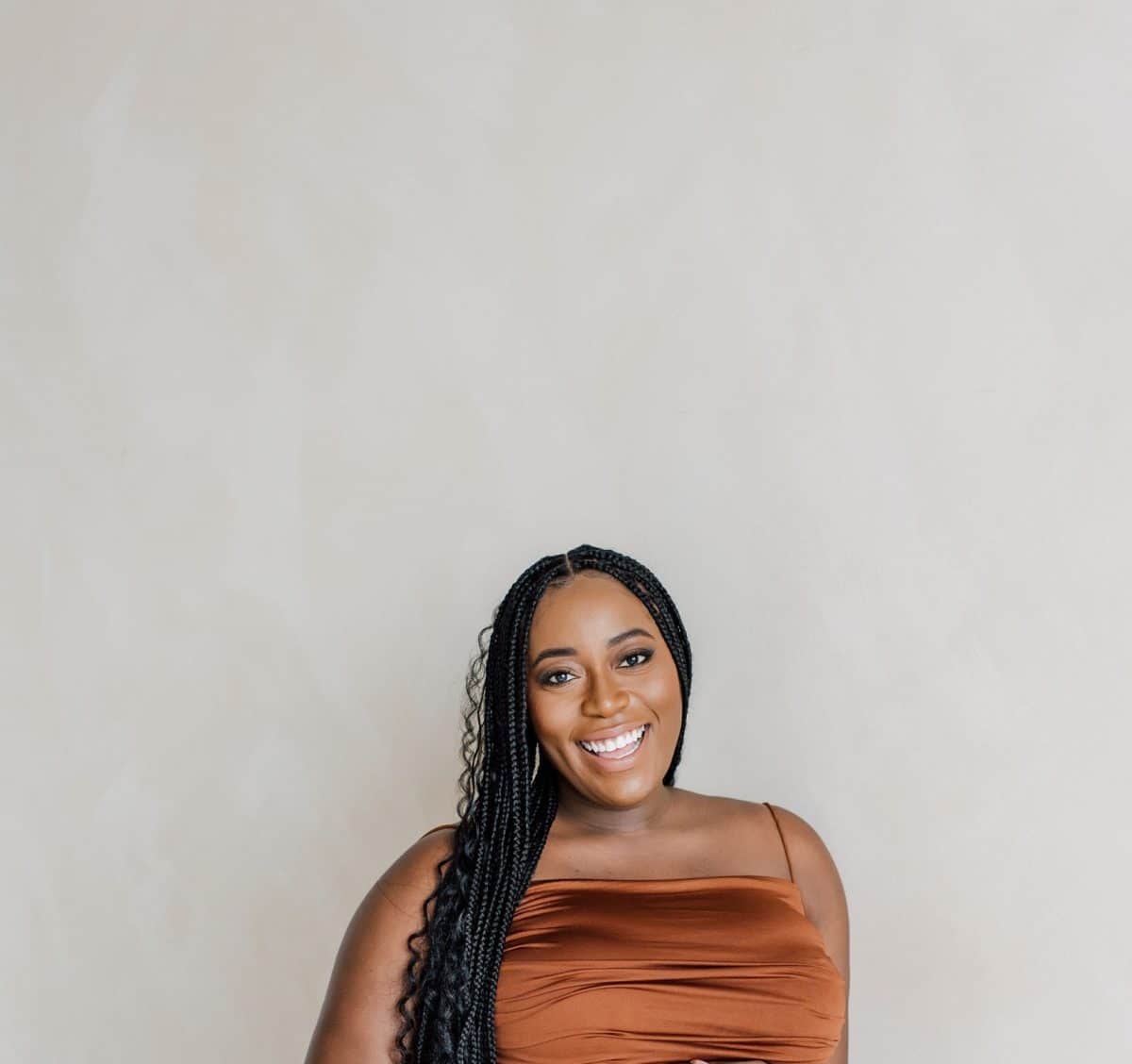 taneisha smiling in brown dress.