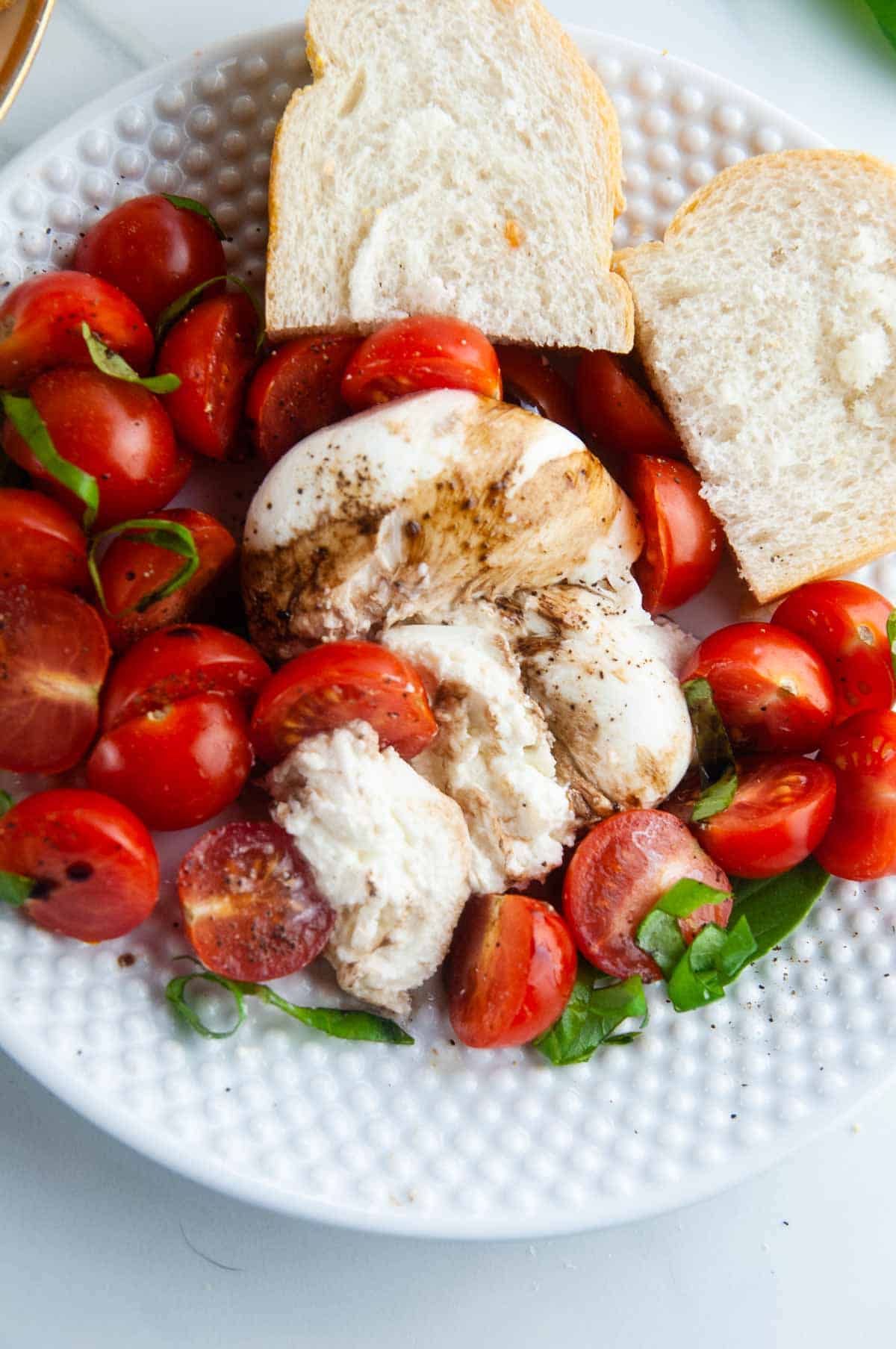 Burrata caprese salad takes the classic flavors of the tomato, mozzarella, and basil combination and turns it up a notch with decadent burrata cheese. This easy variation of caprese with burrata makes for an effortlessly elegant dinner or appetizer anytime.