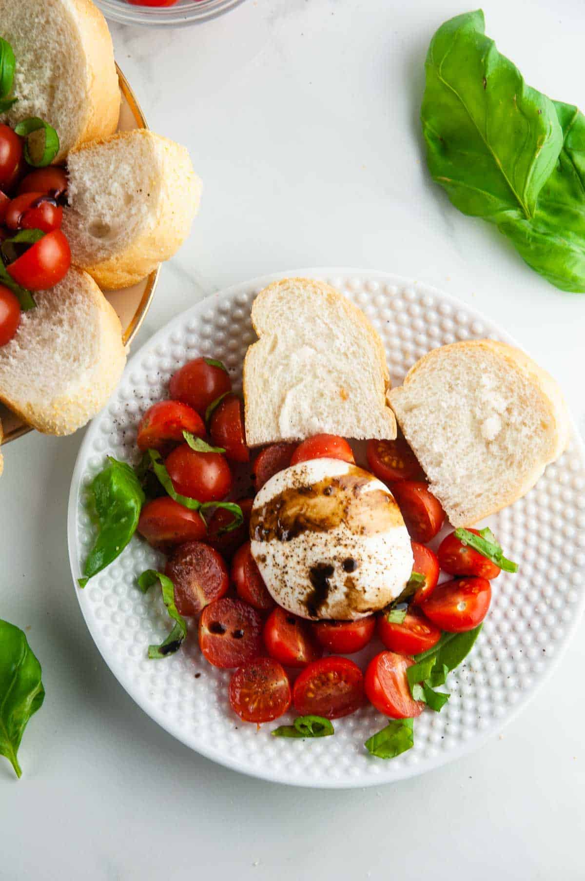 Burrata caprese salad takes the classic flavors of the tomato, mozzarella, and basil combination and turns it up a notch with decadent burrata cheese. This easy variation of caprese with burrata makes for an effortlessly elegant dinner or appetizer anytime.