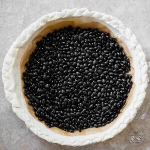 pie crust weighted down with dry black beans