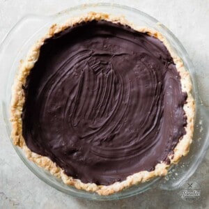 cooked pie crust with a layer of chocolate