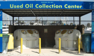 A used oil disposal center featuring two main white bins.