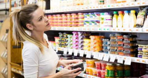 Woman looking at shelf at grocery store.