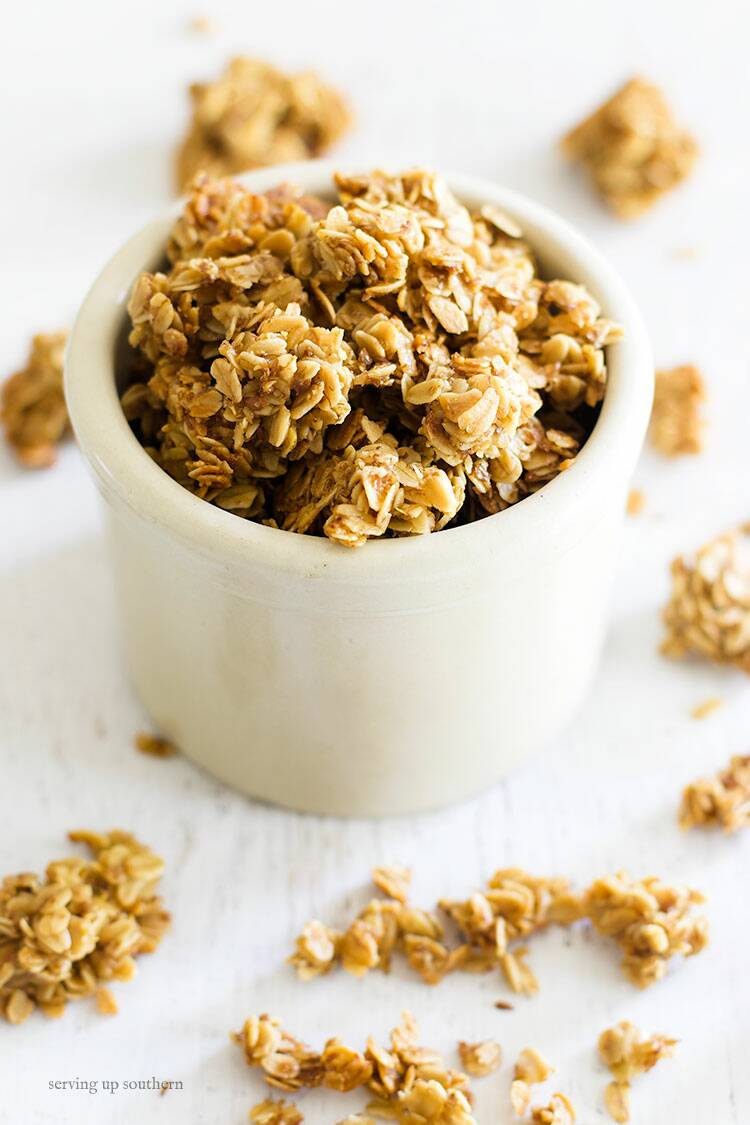 Picture of a small crock filled with homemade granola clusters - fresh toasted and right out of the oven.