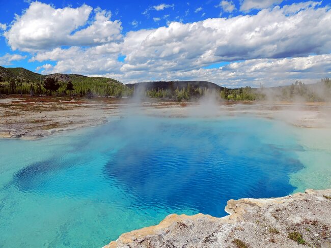 color blue hot spring with vapors