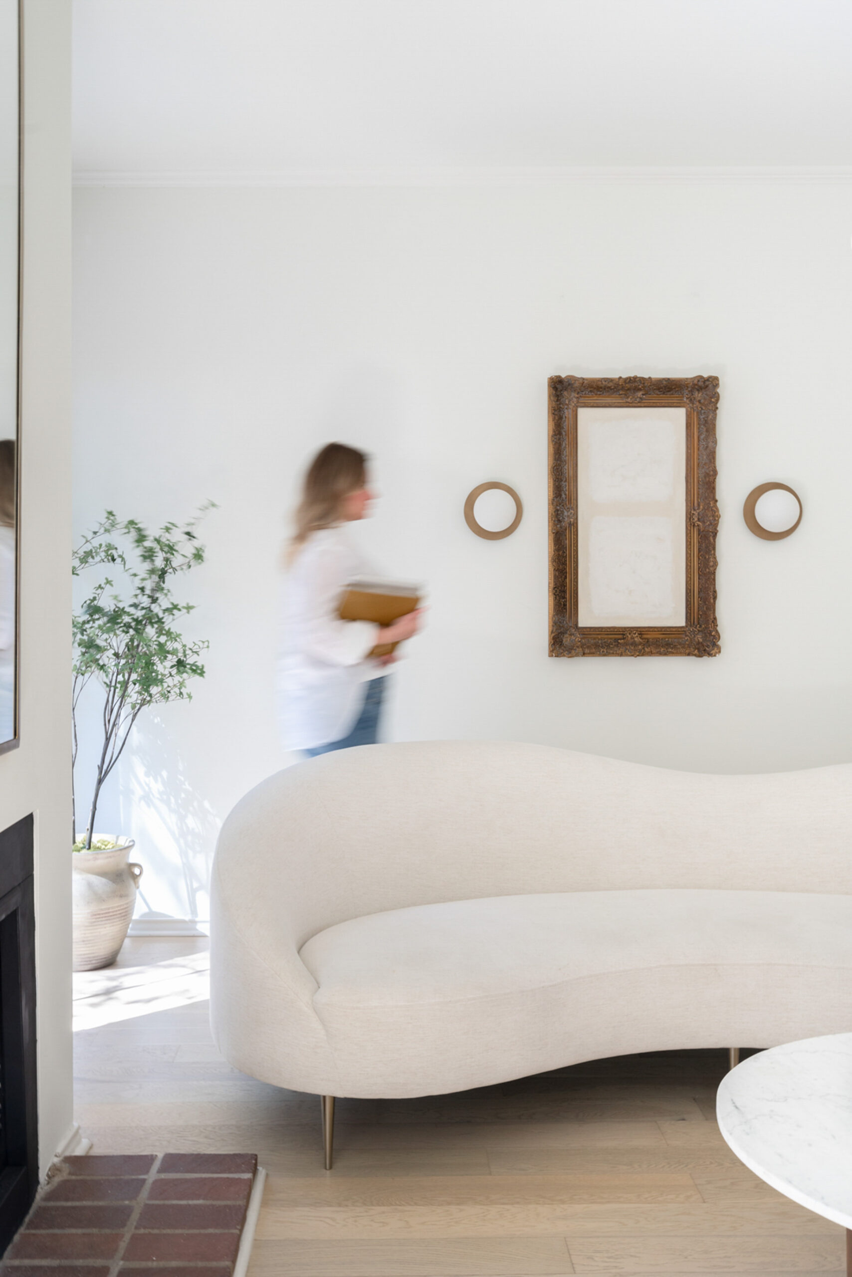 Photo of girl walking by in neutral colored home